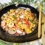 Radieschensalat mit Apfel und Walnüssen auf einen schwarzen Teller, Radieschensalat mit Apfel Rezept