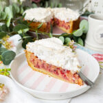 Johannisbeerkuchen Stück mit Baiser auf einer Kuchenplatte serviert